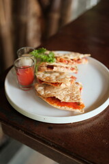 Delicious crispy tostadas with vibrant red salsa offer a flavorful and visually appealing snack or light meal, perfect for a casual dining experience