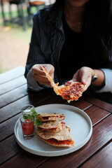 Enjoying a flavorful quesadilla lunch outside on the patio, perfect for lifestyle blogs, casual dining, and trendy food photography projects