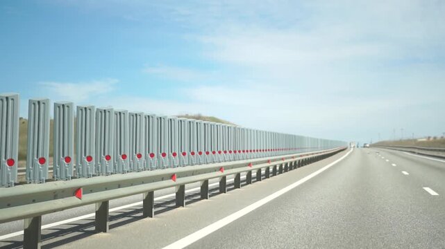 Highway Barrier Safety Security Road - A long row of highway barriers line the side of a road for safety and security.
