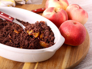Homemade Chocolate peach crumble dessert in a tin