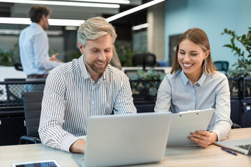 Businesswoman manager showing project presentation to businessman, investor or partner at work meeting