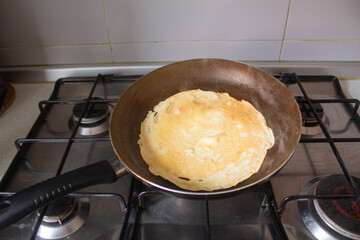 Homemade Pancake in Frying Pan on Gas Stove, First Crepe Cooking at Home, Real Kitchen Atmosphere