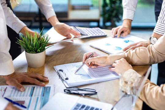Executive business team people group working with documents at table, analyzing corporate strategy, reviewing plan, managing financial project overview at office meeting, digital tablet, laptop.
