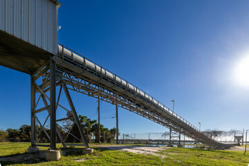  conveyer belt at concrete factory against blue sky