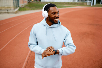 Man tracking fitness progress on running track