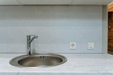 This modern kitchen sink has a stylish stainless steel faucet and a minimalist design, ideal for...