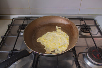 Homemade Pancake in Frying Pan on Gas Stove, First Crepe Cooking at Home, Real Kitchen Atmosphere