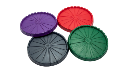 Four colorful, ribbed, circular plastic components with central holes, against black