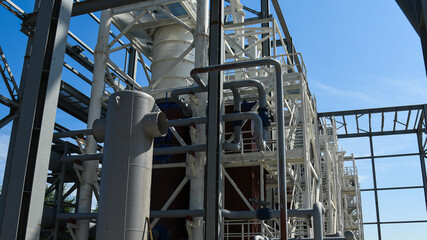 A building structure made of metal beams forming the frame of a building or structure, against a blue sky background.