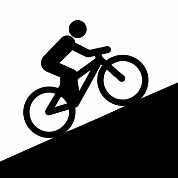 Silhouette of a cyclist riding uphill indicating mountain biking or difficulty