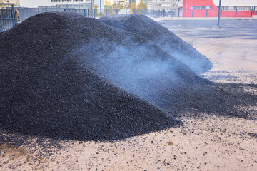 Heavy Machinery Loading Black Aggregate Material at the Construction Site for Development