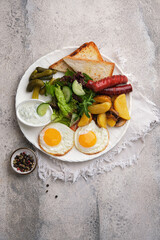 A delicious breakfast plate with eggs, sausages, and colorful vegetables