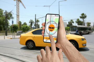 Man using app on mobile phone to call taxi on city street, closeup