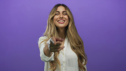 Woman pointing finger in studio; invitation connection.