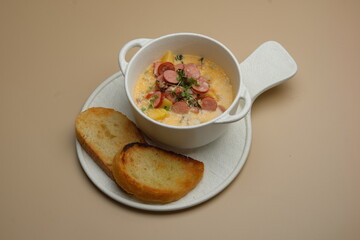 A Delicious Bowl of Creamy Soup Accompanied by Toasted Slices