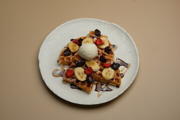 Indulge in Delicious Waffles Generously Topped with Fresh Fruits and