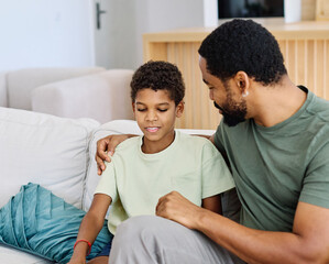 Obraz premium Portrait of a happy teenage boy son talking to his father at home. Sharing secrets and having fun, support and parenthood concept