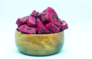 Ripe Dragon Fruit or Pitaya Cube or Slices in a Wooden Bowl Isolated on White Background with Copy Space