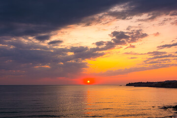 dramatic sky at sunrise at the sea. wonderful atmospheric background for wallpaper. stormy clouds above the water. sun over horizon. nature landscape of sozopol bay in summer. warm colorful gradient