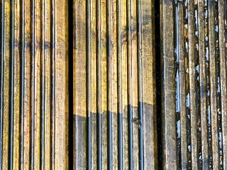 Before and after view of dirt and grime being cleaned from wooden decking using a pressure washer. DIY concept.