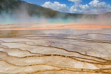 Yellowstone, Wyoming, USA - 28 May 2025: Scenic view of water running over mineral deposits at the Grand Prismatic Spring in Yellowstone National Park,.