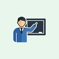 Teacher pointing at a blackboard with chalk.