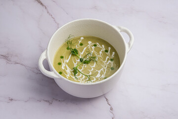 Delicious and Creamy Soup Featuring a Beautiful Green Garnish Served