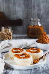 Spicy rice donuts with miso paste on a plate on the table vertical view