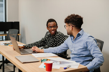 Business colleagues collaborating on project in office