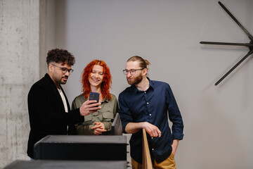 Diverse business team sharing content on smartphone