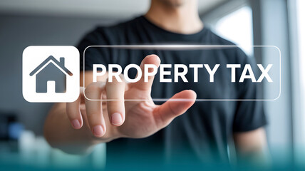 Man's hand touches digital screen displaying 'PROPERTY TAX' with house icon, symbolizing homeownership finance and real estate management