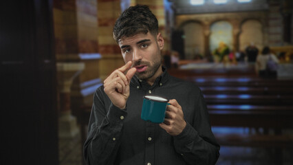 Man pinches fingers to show small amount while holding blue enamel mug at church pew; contemplation.
