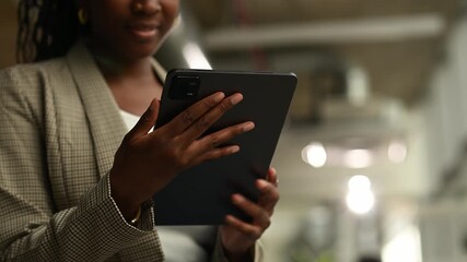 African american businesswoman using digital tablet in modern office - Powered by Adobe