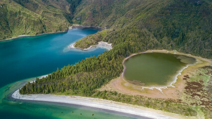 Twin crater lakes separated by forested ridge
