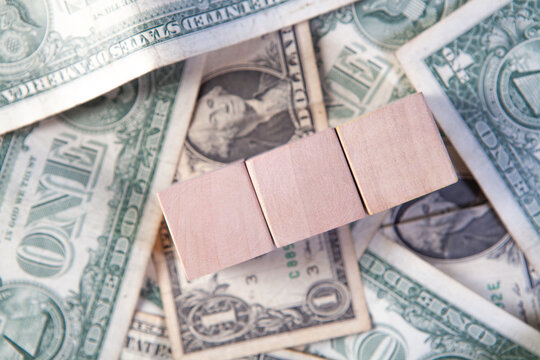 Wooden blocks with dollar banknotes. Business and finance concept.