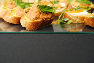 Delicious sandwiches arranged on a glass platter, garnished with fresh herbs, showcasing vibrant colors and textures, perfect for culinary presentations with copy space