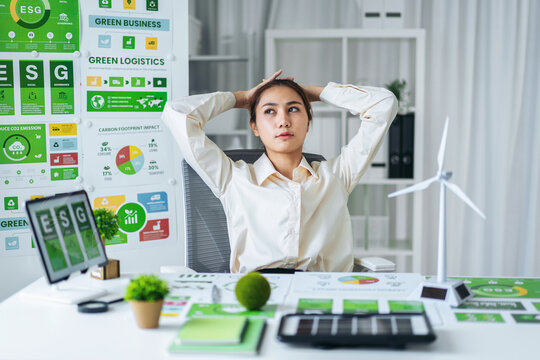 Professional woman analyzing crucial ESG environmental social governance strategy developing green business initiatives at office - Powered by Adobe