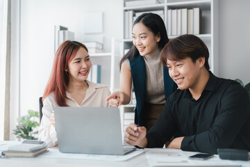Asian Business Team Collaboration on Laptop in Modern Office for Startup Success Teamwork Brainstorming Meeting Workplace Strategy