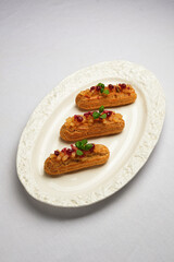 elegant pastry display, sophisticated display of gourmet eclairs adorned with