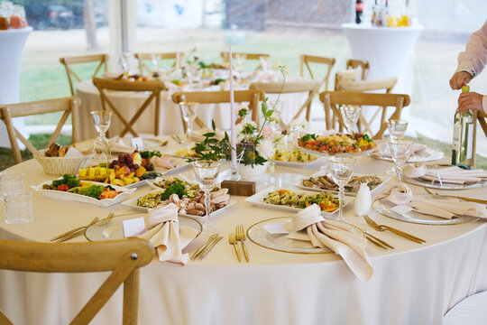 Elegant wedding menu displayed on a beautifully set table with gourmet dishes, fine glassware, and floral decorations, creating a romantic dining atmosphere for guests - Powered by Adobe