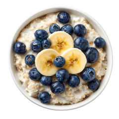A delicious looking white bowl of oatmeal topped with fresh blueberries and banana slices isolated on a black background