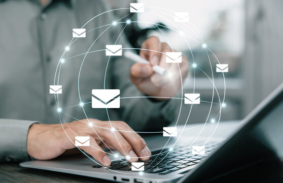 Businessman sending email by laptop computer to customer, business contact and communication, email icon, email marketing concept, send e-mail or newsletter, online working internet network.
