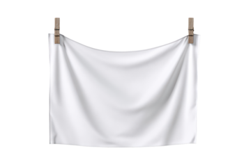A clean white cloth hangs from two wooden clothespins against a plain black background creating a simple and minimalist scene