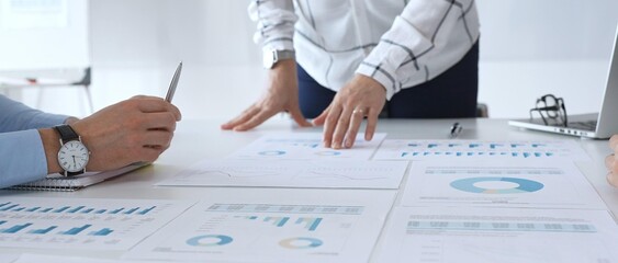 Business team analyzing financial charts and graphs during corporate meeting, focusing on strategy development, data driven decision making, growth and planning