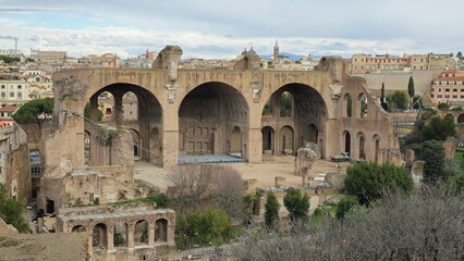 Rome, Italy - 13 January 2025. The towering ruins of the Basilica of Maxentius with three surviving barrel vaults rise above the Roman Forum.