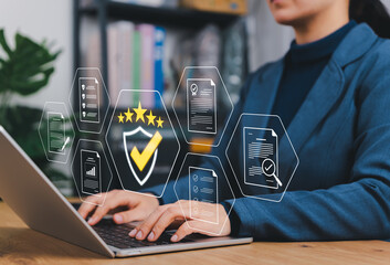 Quality Assurance and Compliance Concept. Businesswoman using laptop with icons representing quality control, document verification, audit, certificate, approval, data management, compliance assurance