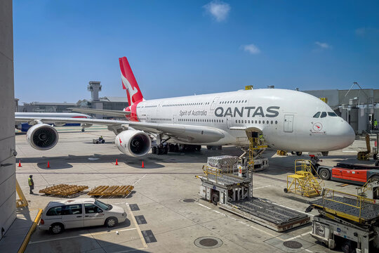 Los Angeles, California, USA - April 19, 2024: Qantas Airbus A380 being prepared for departure at Los Angeles International Airport LAX, with ground crew and loading equipment in action