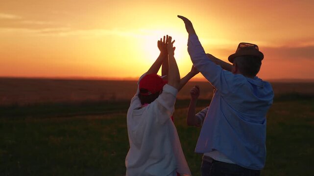 People dancing to music, raising their hands, outdoor party. Family party, dancing, group of happy people raising their hands to sky in evening. People, celebration, picnic, cheerful dancing nature