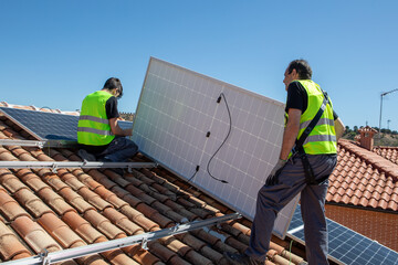 Solar panel installation process on residential roof in sunny weather by skilled workers