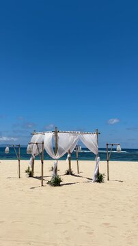 Serenity Under the canopy, baldachin bed on a white-sand beach, vertical